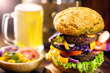 vegan burger on wholemeal bread with cold beer in the background. Vegetarian snack without meat and without a milk-based product, without eggs.