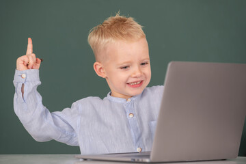 Amazed child using gadgets to study. Computer education for kids. Genius child programming, computer training.