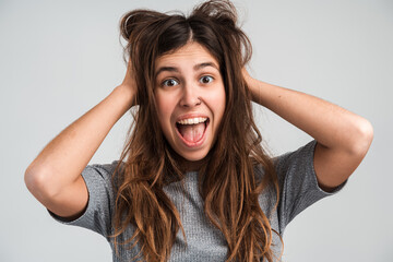 Extremely satisfied woman celebrating her victory rejoicing and showing yes gesture, positive emotions. Indoor studio shot isolated on white background