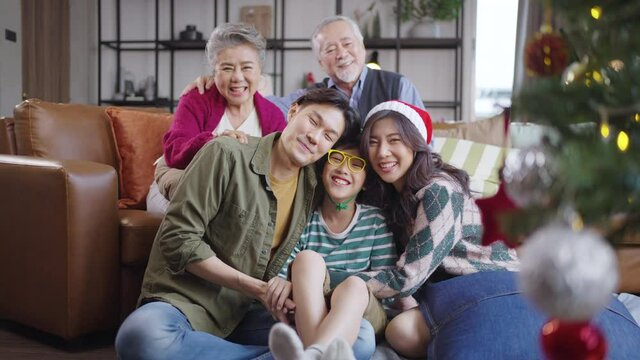 Portrait Asian family near Christmas tree together at home. family, generation, christmas and people concept