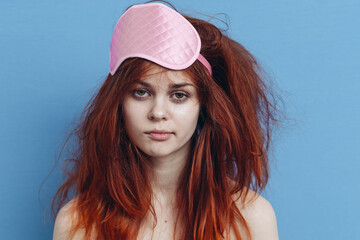 woman with tousled hair sleep mask posing close-up