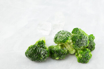 Frozen Green broccoli on a light grey background with copy space. Frozen vegetables. Food Reserve