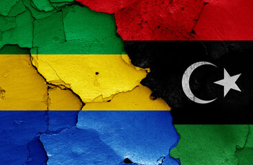 flags of Gabon and Libya painted on cracked wall