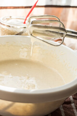 Prepared beaten eggs with a mixer, for making delicious and airy apple biscuit.