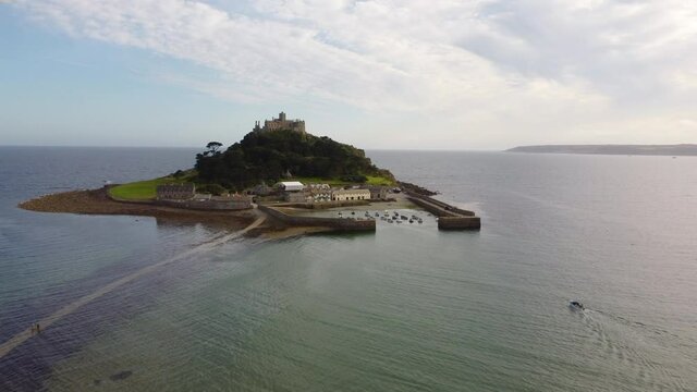 Speedboat heading towards St Michael's Mount near Penzance in Cornwall, England Drone Aerial View - Moving Forward