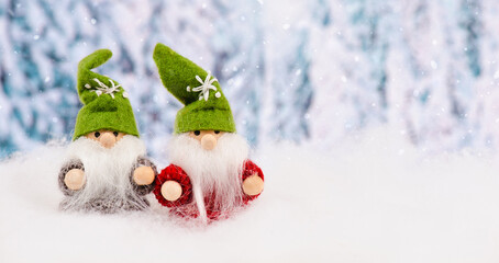 Little cute christmas elves standing in the snow, forest, festive greeting card, copy space,...