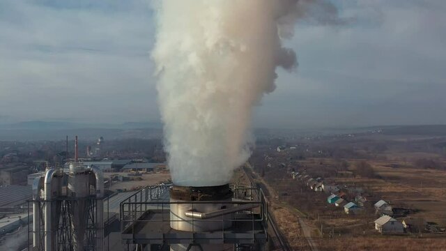 Top view of air pollution by smoke that comes out of big factory chimneys