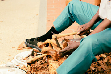 African craftsman works on the city street.