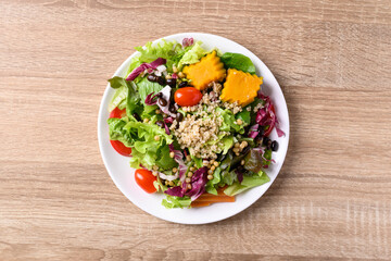 Fresh organic vegetables with quinoa salad on wooden background, Healthy Vegan food, Table top view