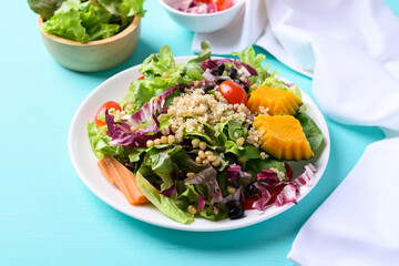 Fresh organic vegetables with quinoa salad on color background, Healthy Vegan food