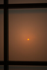 Sunset sun through a window in smoky skies