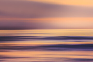 Fototapeta premium Sunset over the ocean, abstract seascape in bright vibrant purple and pink colors, motion blur