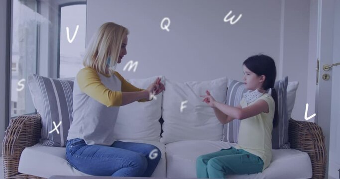 Animation of letters over caucasian woman and her daughter wearing face masks using sign language