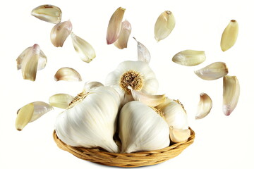  garlic bulb in basket with flying or falling cloves isolated  - Powered by Adobe