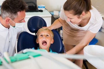 Fototapeta premium Boy with woman are visiting dentist in dental office.