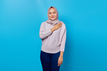 Portrait of smiling asian woman customer support over blue background