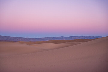 Fototapeta na wymiar Pinks and Purples Of Sunset Over Mesquite Dunes