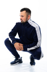 portrait of a man in a tracksuit. man looks at us. isolated white background