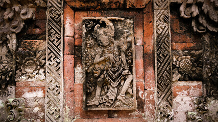a sculpture on a temple wall that tells the story of a Hindu wayang