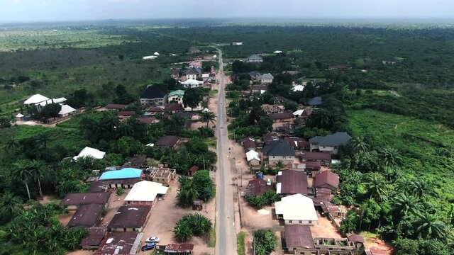 A road through the Awa Community in the Imo State of Nigeria - pull back flyover aerial scenic view