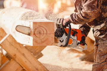 Close-up chainsaw of woodcutter sawing chain saw in motion, sawdust fly to sides. Concept...