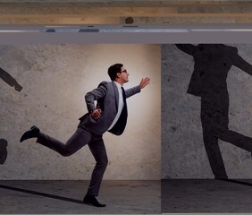 Businessman and his shadow in business concept