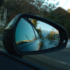 Fototapeta na wymiar landscape in the reflection of the car