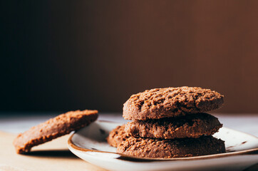cocoa cookies on brown background. copy space. selective focus