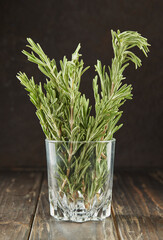 Bouquet of fresh rosemary in glass, herbs to add to food