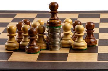 Chess board with pawns and coins, business growth or success and advantage concept.