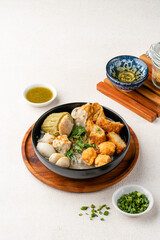 Yong tau foo , yong tau fu or Liong Tahu (In Indonesia). is a Hakka Chinese cuisine consisting primarily of tofu filled with ground meat mixture or fish paste.