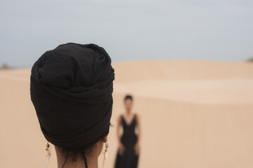 Rear view of woman with headwrap at the beach