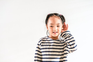 Happy Positive cute Asian little toddler kid girl holding ear with hand listening to a hearing for...