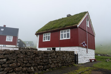 The beautiful town of Mykines with its classic Grass roof houses on a foggy day