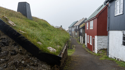 The beautiful town of Mykines with its classic Grass roof houses on a foggy day