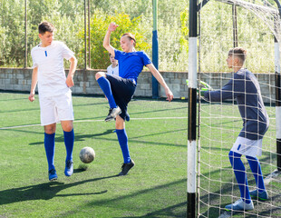 Football game - defender knocks ball from the attacker