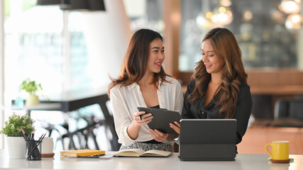 Businesswomen discussing work in office.