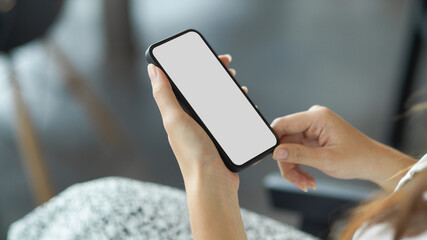 Woman hands holding smart phone with mockup white blank display