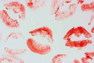 Set of sexy pink red female lip prints on white paper background top view. Kisses flatly. Lipstick prints, marks. Femininity, flirt, love concept. World Kissing Day. Valentine's Day. Lovely backdrop.