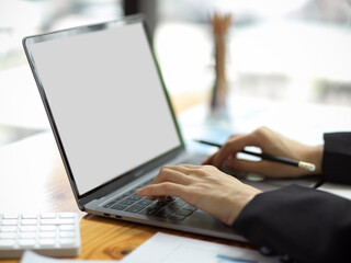 Close-up Businesswoman typing on laptop keyboard