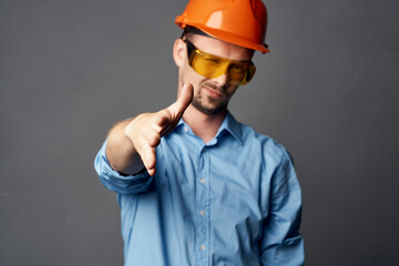 man in orange hard hat blue shirt construction design