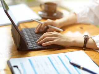 Cropped image of Female doctor working on her digital tablet