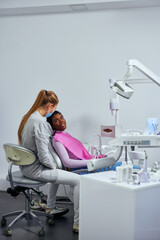 Young african woman at the dentist getting advices