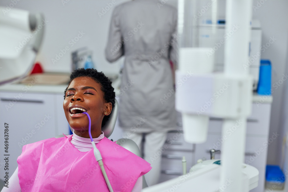 Wall mural African american patient at dentist during treatment