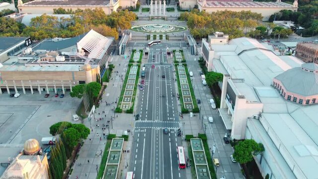 Aerial view of Montjuic in Barcelona, with people walking, public transportation, the Magic Fountain, the National Palace, and five other palaces