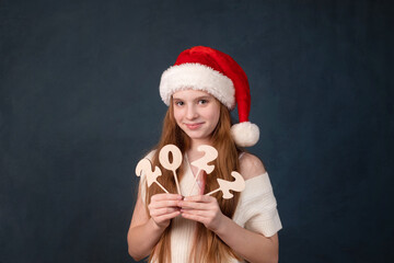emotions of a cute girl from 2022 in a New Year's cap for Christmas.