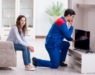 Tv repairman technician repairing tv at home