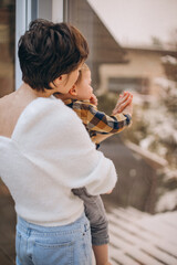 Young mother with son having fun at home