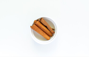 cinnamon sticks on a white plate. High quality photo