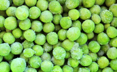 Frozen green peas, vegetables background